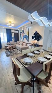 a dining room with a table and a living room at CoZerenity Stays - Premium two-bedroom Condo in Concepcion