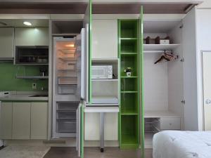 a kitchen with an open refrigerator with a microwave at YN GasanDong Studio in Seoul