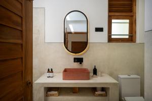 a bathroom with a sink and a mirror at SĀMA Ahangama in Ahangama +13 photos