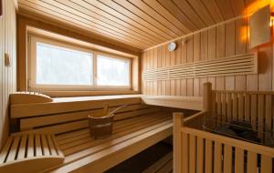 a sauna with a bench and a window at Haus Bergkristall in Sankt Anton am Arlberg