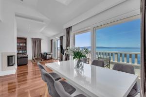 a dining room with a table and chairs with a view at Villa Svilla - Makarska Exklusiv in Drasnice