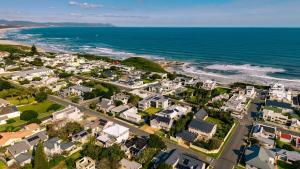 an aerial view of a coastal town with houses and the ocean at Mountainside Family Beach House - Pet Friendly in Hermanus