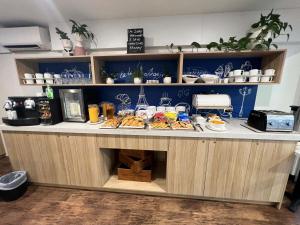 a buffet with food on a counter in a kitchen at ibis Budget - Gosford in Gosford