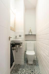 a white bathroom with a toilet and a sink at Santander Centro in Santander