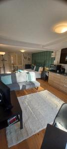 a living room with two beds and a television at The Studio, in Saint-Rabier