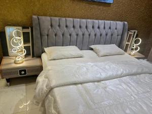 a bedroom with a large bed with a large headboard at Cairo original hotel rooms in Cairo