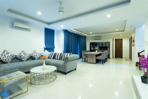 a living room with a couch and a table at Laguna Park Phuket in Bang Tao Beach