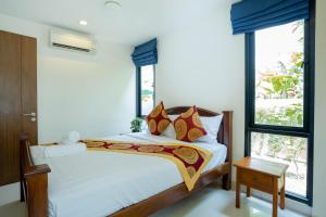 a bedroom with a bed and a window at Laguna Park Phuket in Bang Tao Beach