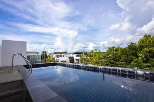a swimming pool on the roof of a house at Laguna Park Phuket in Bang Tao Beach