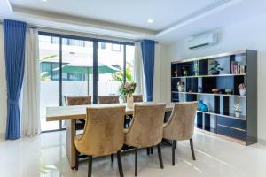 a dining room with a table and chairs at Laguna Park Phuket in Bang Tao Beach