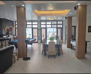 a dining room with a table and a pool table at Clarin's Beach in Sampong