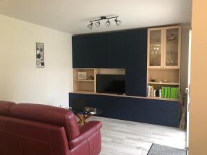 a living room with a couch and a television at Maison d'hôtes à Castres-Saïx in Saix