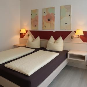 a bed in a room with two pillows on it at Hotel Skada City Cölln in Cologne