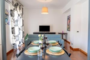 a dining room with a table and a couch at Villa Linda con Terrazzo in Giardini Naxos