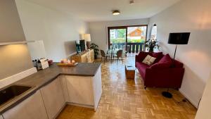 a kitchen and living room with a couch and a table at Studio Bergblick 5 in Garmisch-Partenkirchen