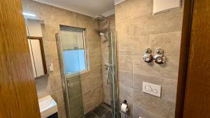 a bathroom with a shower with a glass door at Studio Bergblick 5 in Garmisch-Partenkirchen +18 photos