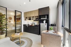 a living room with a couch and a table at Caraya by Kozystay - Nusa Dua in Nusa Dua