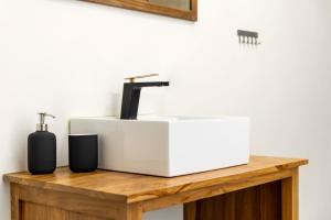 a bathroom sink on a wooden counter next to a mirror at Apartamento Italia 2, Newly Renovated, AC & WiFi in Rincón de la Victoria +9 photos