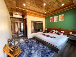 a bedroom with a large bed and green walls at Alley Homestay SaPa in Sa Pa +23 photos