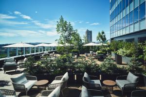 a patio with chairs and tables and a building at InterContinental Sapporo by IHG in Sapporo