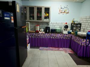 a kitchen with a purple counter top in a kitchen at Forest Way Home Sepilok Sandakan in Sandakan