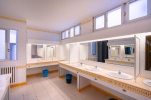a large bathroom with three sinks and two mirrors at Kampaoh Benicàssim in Benicàssim +31 photos