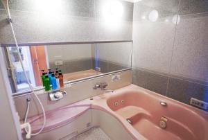 a pink tub in a bathroom with a mirror at ホテル韮崎インター in Nirasaki +31 photos