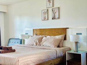 a bedroom with a bed and two pictures on the wall at Laem Tukkata beach Koh Mak in Ko Mak