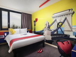 a hotel room with a bed and a bridge at ibis Styles Budapest Citywest in Budapest
