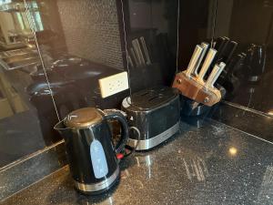 a counter top with a coffee pot and a toaster at 2 bedroom pool villa, near Pattaya city centre in Pattaya South +20 photos