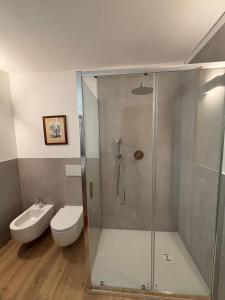 a bathroom with a shower with a toilet and a sink at Casa Momi b&b and in Novilara +10 photos
