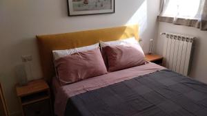 a bed with two pillows on it in a bedroom at Casa Momi b&b and in Novilara