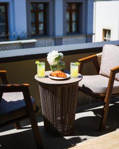 a table with a plate of food and drinks on a patio at The Wings Hotels Pera in Istanbul