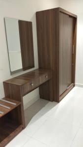 a dressing room with a mirror and a wooden cabinet at رير بلو دايموند 2 للشقق المخدومة تصنيف اقتصادي in Taif