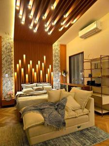 a bedroom with a bed and a couch in it at Home atmos prime villa pattaya in Ban Hui Yai Muk +33 photos