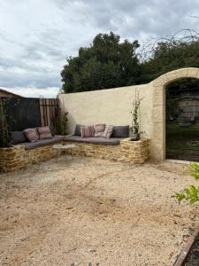a couch sitting on top of a stone wall at Suite Prestige in Codolet