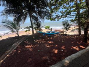 a blue boat sitting on the beach near the ocean at Rocks beach house in Kannur