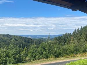 a road in the middle of a forest at La maison la Borie in Baffie