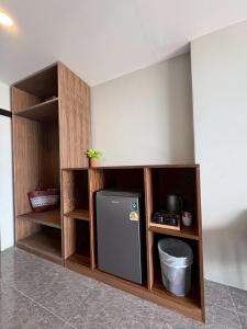 a kitchen with a small refrigerator in a shelf at Bliss Resort Krabi in Klong Muang Beach