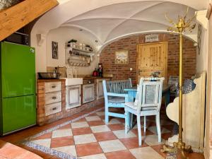 a kitchen with a green refrigerator and two chairs at Nasze Chabazie in Olszyna +68 photos
