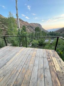 a wooden deck with a view of the mountains at Green Garden 