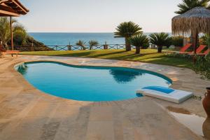 a swimming pool with a view of the ocean at Atlas Villa in Kástro Tornéze