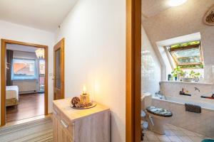 a bathroom with a tub and a toilet and a sink at Ferienwohnung im Ländlichen Raum in Reuthen +16 photos