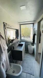 a bathroom with a sink and a toilet and a window at Frascati Tower B&B in Frascati +12 photos