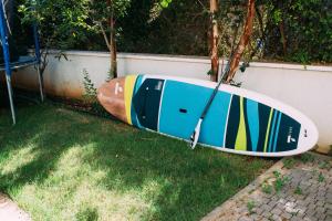 two surfboards sitting on the grass next to a wall at Shavei Zion studio in Shave Ẕiyyon