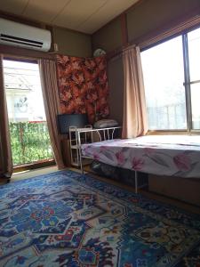 a bedroom with a bed and a rug on the floor at Yuzu House - Vacation STAY 19174 in Chofu