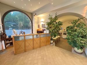 a lobby with two large potted plants and a counter at Agriturismo Il Trappeto in Gallipoli