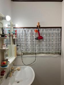 a bathroom with a sink and a shower curtain at Yuzu House - Vacation STAY 19174 in Chofu +10 photos