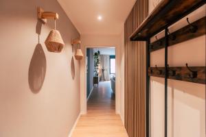 a hallway of a home with wooden floors and lights at Luga Homes - Augustusplatz in Leipzig