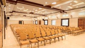 an empty room with a large room with chairs at Ganesh Residency 